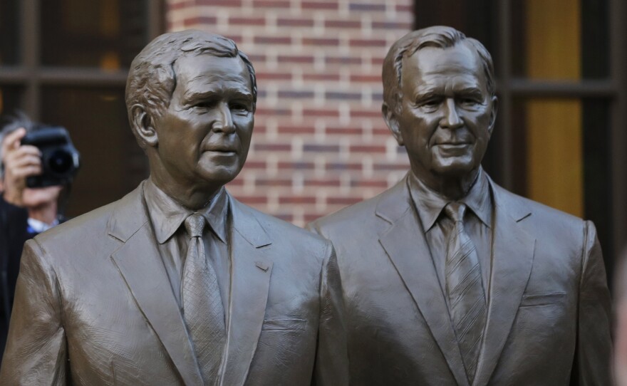 Statues of former presidents George W. Bush (left) and his father, George H.W. Bush, greet visitors to the George W. Bush Presidential Library in Dallas.