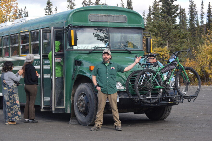 Denali National Park driver Will Moran in front of his shuttle bus on Sept. 12, 2026.
