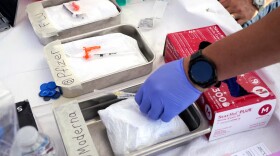 Syringes with vaccines are prepared at the L.A. Care and Blue Shield of California Promise Health Plans' Community Resource Center on Oct. 28, 2022, in Lynwood, Calif.