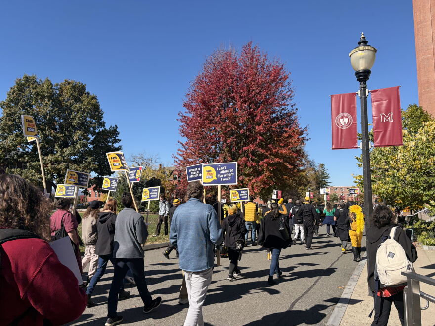 UMass Amherst union members rally on campus demanding fair wages.