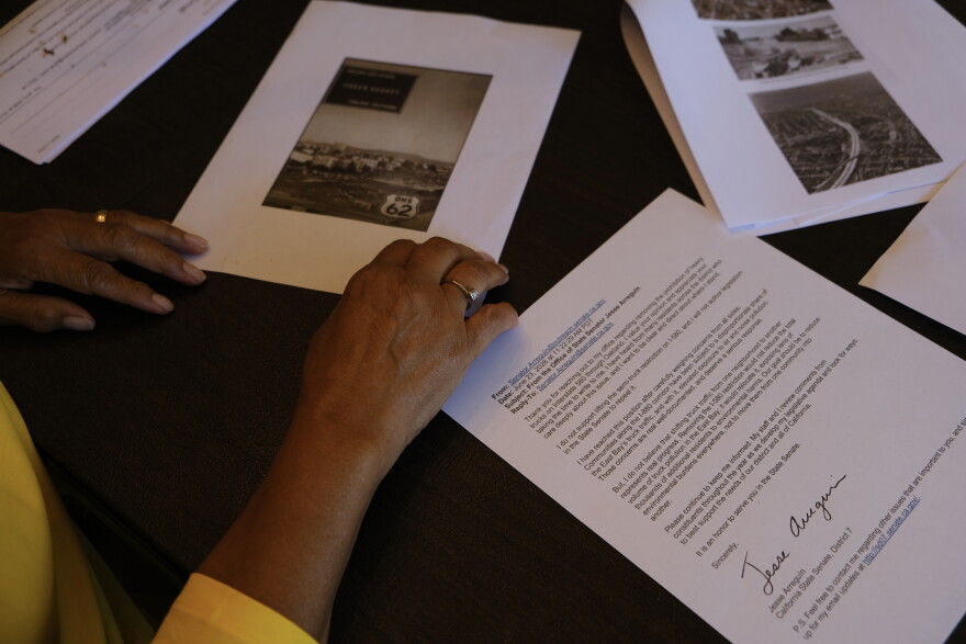 Sandi Bethune looks through documents and photos from the construction of I-580 in the 1960s.