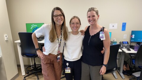Three women: Dr. Lauryn Roth, Dr. Aubrey Armento, and sports nutritionist Amanda McCarthy, smile for a photo in their clinic. They are part of the new Female Athlete Program at Children's Hospital Colorado