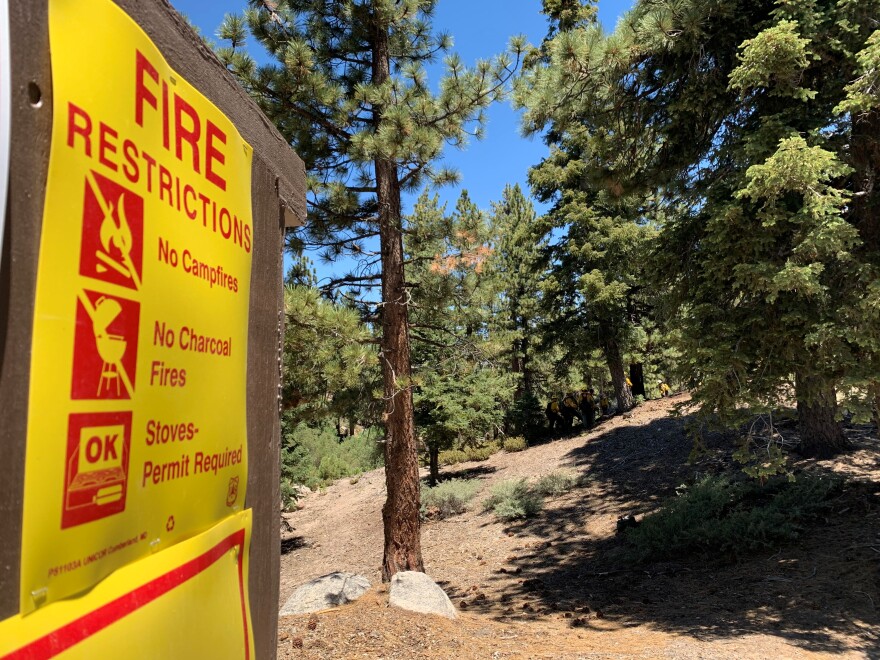 A sign in the San Bernardino National Forest listing different fire restrictions.