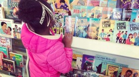 A young shopper surveys the offers at EyeSeeMe African American Children's Bookstore.