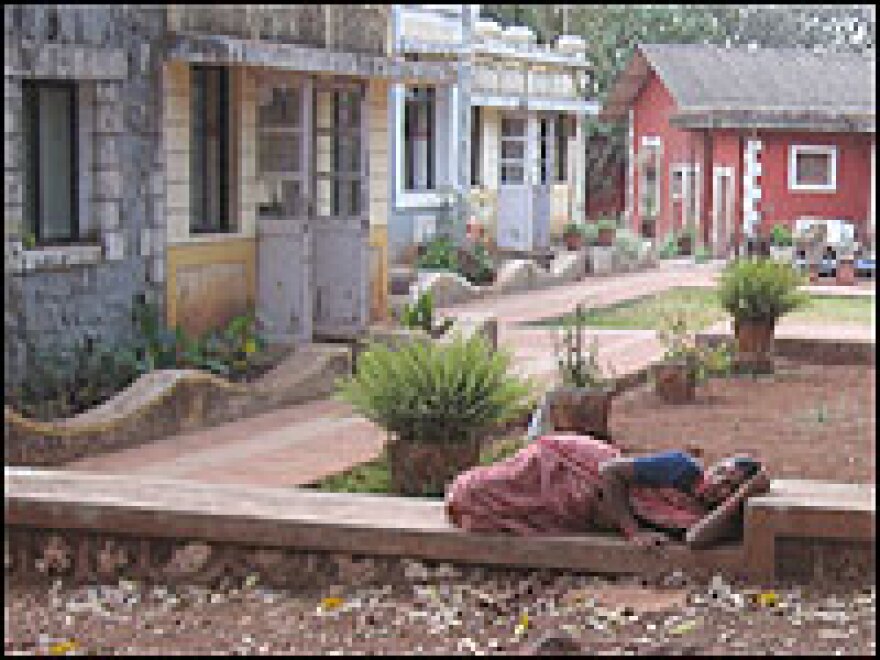 A woman rests outside the gynecological ward building at Bel-Air Hospital.