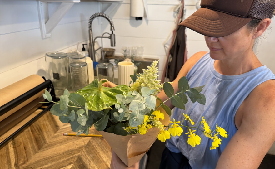 Hōlualoa small business owner Mandi Cooperson was behind the counter wrapping up flower arrangements on Saturday morning (Sept. 26, 2026).