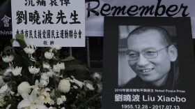 A portrait of late Chinese Nobel Peace laureate Liu Xiaobo is displayed for mourning outside the Chinese liaison office in Hong Kong, Friday, July 14, 2017. (Kin Cheung/AP)