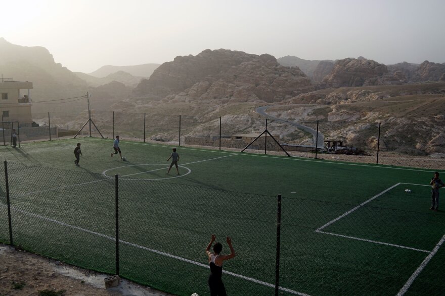 Boys play soccer on a field in the Bedouin village of Um Sayhoun, near Petra.