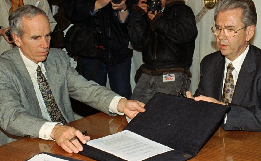 Douglas Tompkins (left) and Juan Villarzu, chief of staff of the Chilean president, with the text of a 1997 agreement permitting the development of a huge nature sanctuary in southern Chile.