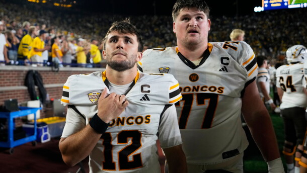 Western Michigan quarterback Broc Lowry (12) and Hunter Whitenack (77) watch from the bench at the end of the second half of an NCAA college football game against the Michigan Saturday, Sept. 5, 2026, in Ann Arbor, Mich.