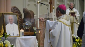 Bishop Robert McClory incenses a picture of the late Pope Francis at the Cathedral of the Holy Angels in Gary on April 26 .
