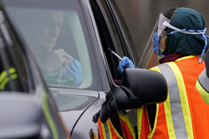 A healthcare worker prepares to administer the Pfizer COVID-19 vaccine Thursday, Feb. 11, 2021 at PNC Arena in Raleigh, N.C. Wake County Health Department workers along with nurses and volunteers from area hospitals distributed vaccines to persons with appointments during the drive through event. Since North Carolina began administering the vaccine in December, more than 1 million people have gotten their first doses.