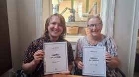 Jadon Cruzan, left, and Four Corners Community Band Director Karen Steele hold copies of the score for Cortez Overture, which Cruzan will conduct during its world premiere on Aug. 15 at the Cortez Cultural Center.