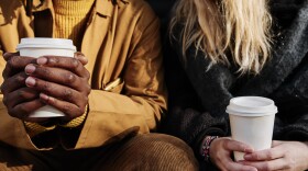 Friends holding cups of coffee. (Getty Images)
