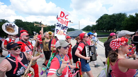 A group of local activist from Washington DC, demonstrating during the March on Washington rally at the Lincoln Memorial on the National Mall, Friday, Aug. 28, 2026 in Washington.