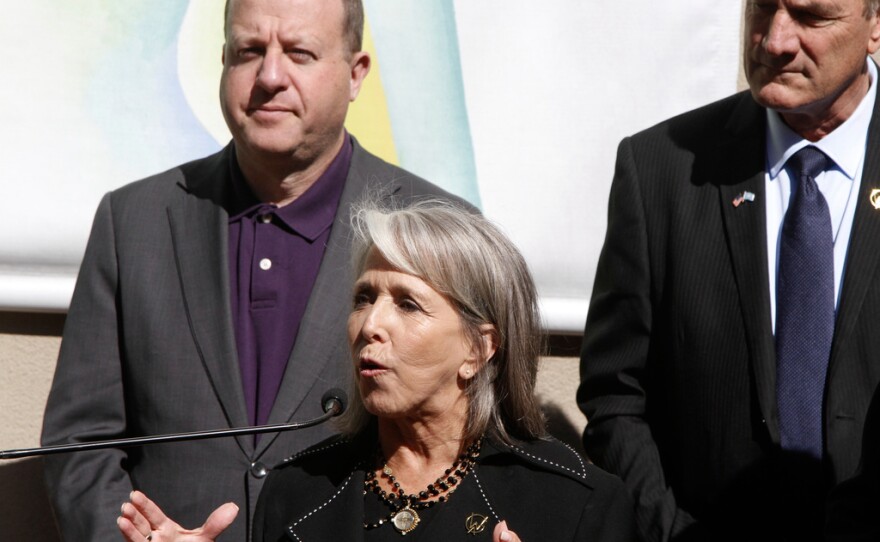 CAPTION CORRECTS THE ID - Governor Michelle Lujan Grisham of New Mexico, center, watched by Governors Larry Rodin of South Dakota, right, and Jared Polis of Colorado, talks about priorities for affordable housing and public lands in Santa Fe, N.M., on Monday, June 23, 2025, at a meeting of the Western Governor's Association. (AP Photo/Morgan Lee)
