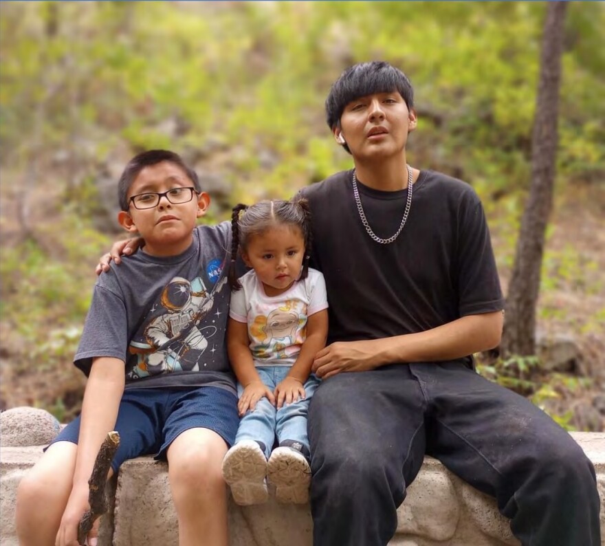 Elijah Hadley with two young family members.