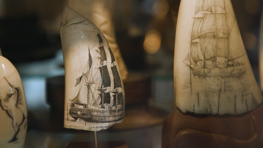 Scrimshaw art pieces depicting whaling ships.