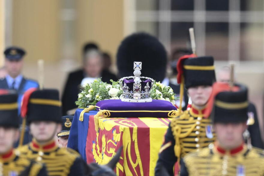 A view of the coffin of Queen Elizabeth II, adorned with a Royal Standard and the Imperial State Crown and pulled by a Gun Carriage of The King's Troop Royal Horse Artillery, during a procession from Buckingham Palace to Westminster Hall in London, Wednesday, Sept. 14, 2022. The Queen will lie in state in Westminster Hall for four full days before her funeral on Monday Sept. 19.
