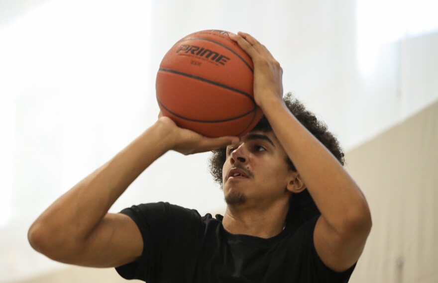 David Johnson, 16, is ranked fifth nationally by ESPN in the Class of 2029 despite having played basketball for only about three years. Johnson credits coach Mitchell Harris and the Hoop N’ Holla summer basketball camp with supporting his development as a player.