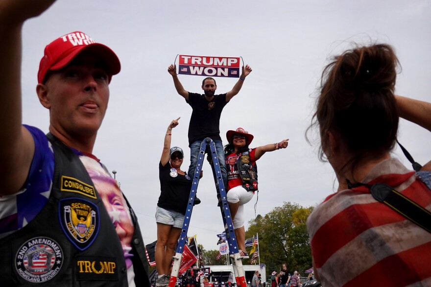 Guests arrive for a rally with former President Donald Trump at the Iowa State Fairgrounds. Like Trump, his fans continue to perpetuate the "big lie."