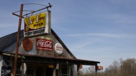 The exterior of the Penny Grocery Museum, covered in vintage signs.