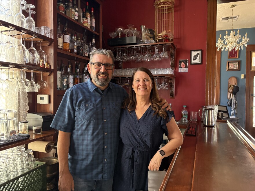 Man and woman smiling in front of winery