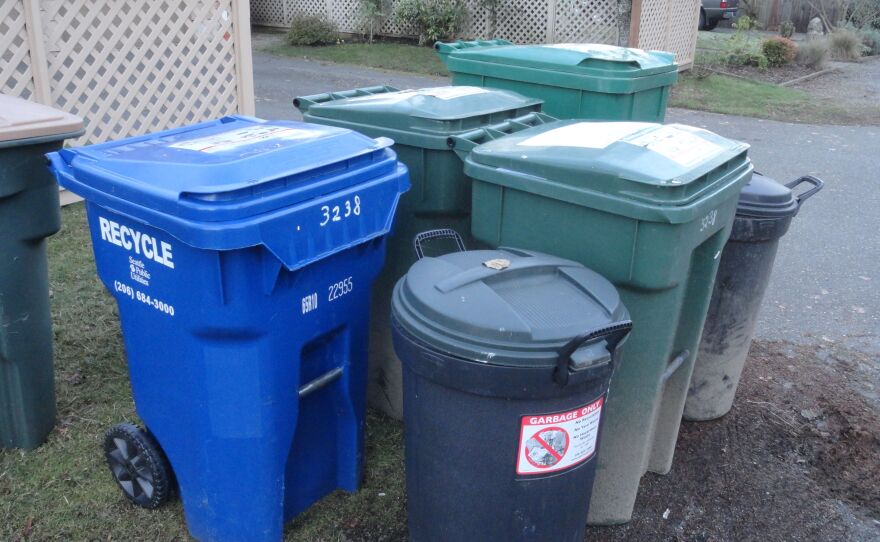 Photo of 5 garbage and recycling containers