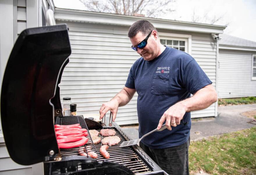 Dan Sullivan gets the grill going for the first time of the season on Monday, May 3, 2021, at his home in Lewiston, Maine.