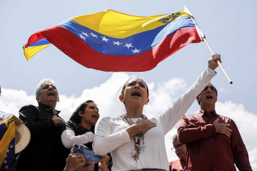Opposition leader Maria Corina Machado waves a Venezuelan national flag during a rally to protest official results that declared President Nicolas Maduro the winner of the July presidential election, in Caracas, Venezuela, Aug. 17, 2024. (Cristian Hernandez/AP)
