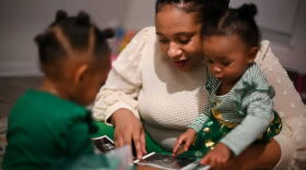  Alexandria Robertson shows her daughters Novah Wilson and Kellani-Ari Wilson ultrasound pictures from her pregnancies in their home in Manor on Thursday. 