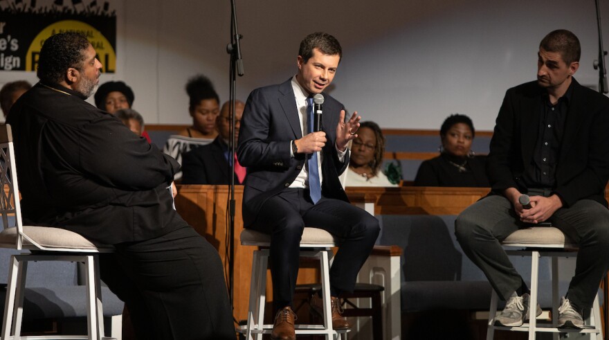 Democratic Presidential Candidate Pete Buttigieg, middle, speaks as Rev. Dr. William Barber II, left, and Jonathan Wilson-Hartgrove, right, listen during a town hall event organized at Greenleaf Christian Church in Goldsboro, N.C., Sunday Dec. 1, 2019.