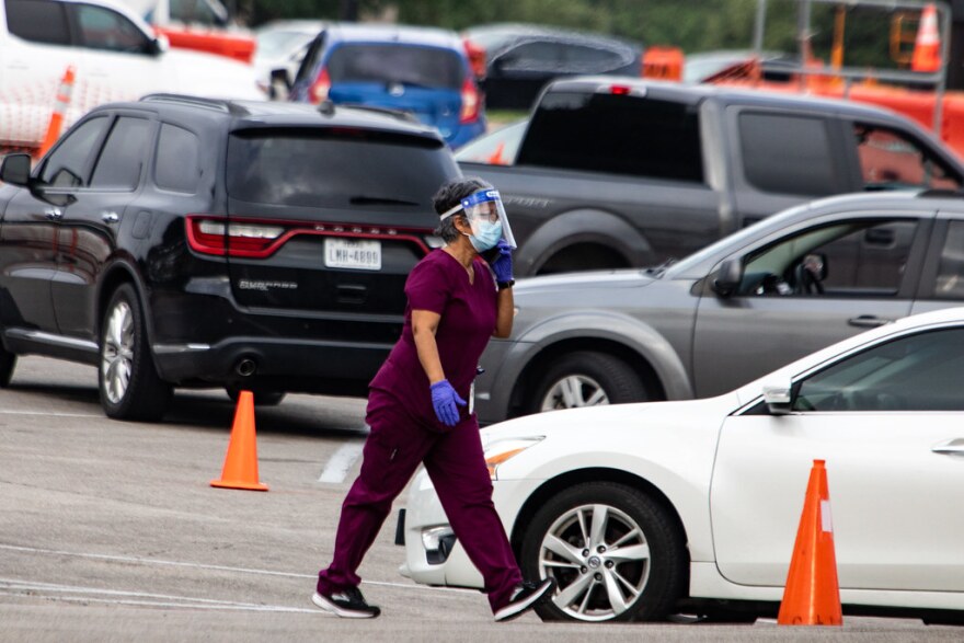 Cars in line for drive-thru testing at the CommUnityCare Hancock Clinic on July 2.