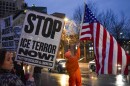 Residents stand along 9th Street, north of city hall, to protest the killing of former Kansas City resident Renee Nicole Good by an Immigration & Customs Enforcement officer.