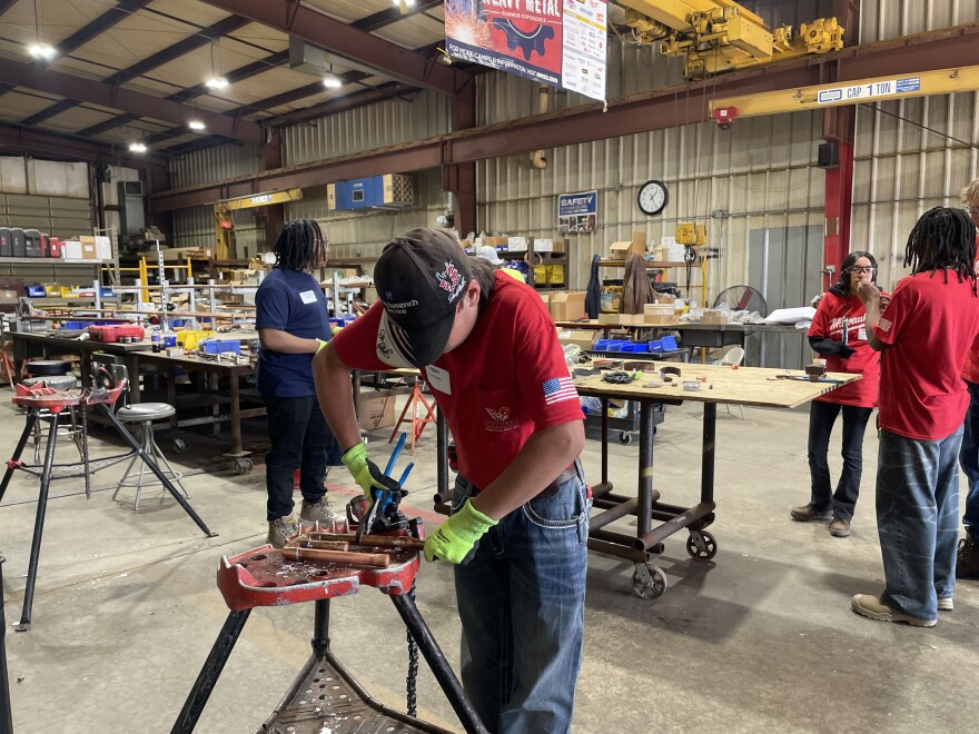 Loan Prochaska solders copper pupes together at Gunrau Company in Oak Creek. Prochaska is one of 20 students from across southeastern Wisconsin participating in the weeklong trades-focused summer camp.