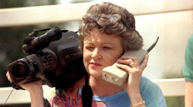 Lucy Morgan with video camera and phone.