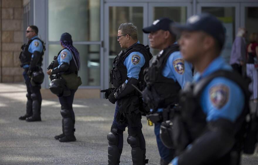 Puerto Rican police officers stand outside of the convention center during a conference held by the Fiscal Control Board for Puerto Rico to manage a planned protest that never materialized. Island residents are unhappy with the the austerity measures recommended by the Fiscal Control Board and the local government which could result in public school closings, pension cuts and reduced paid sick and vacation days. (Jesse Costa/WBUR)
