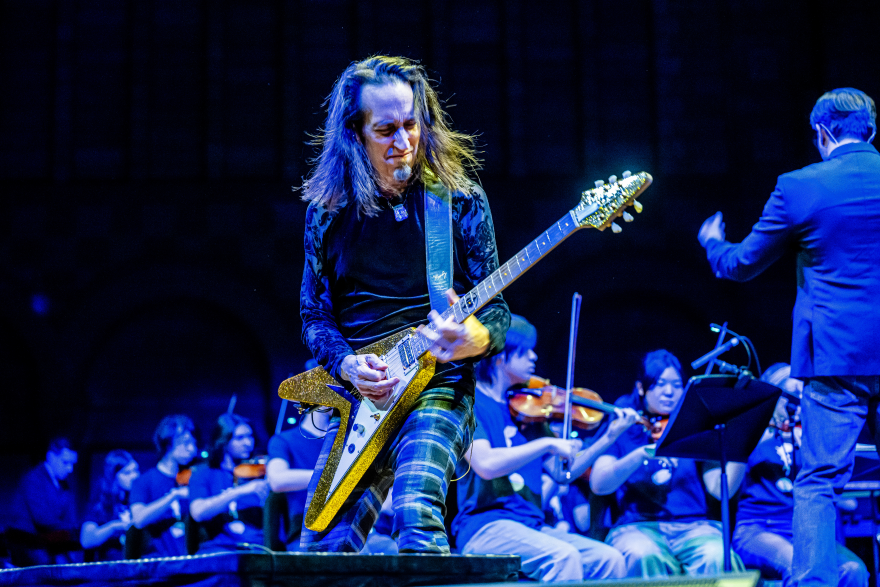 Neil Zaza plays guitar on stage
