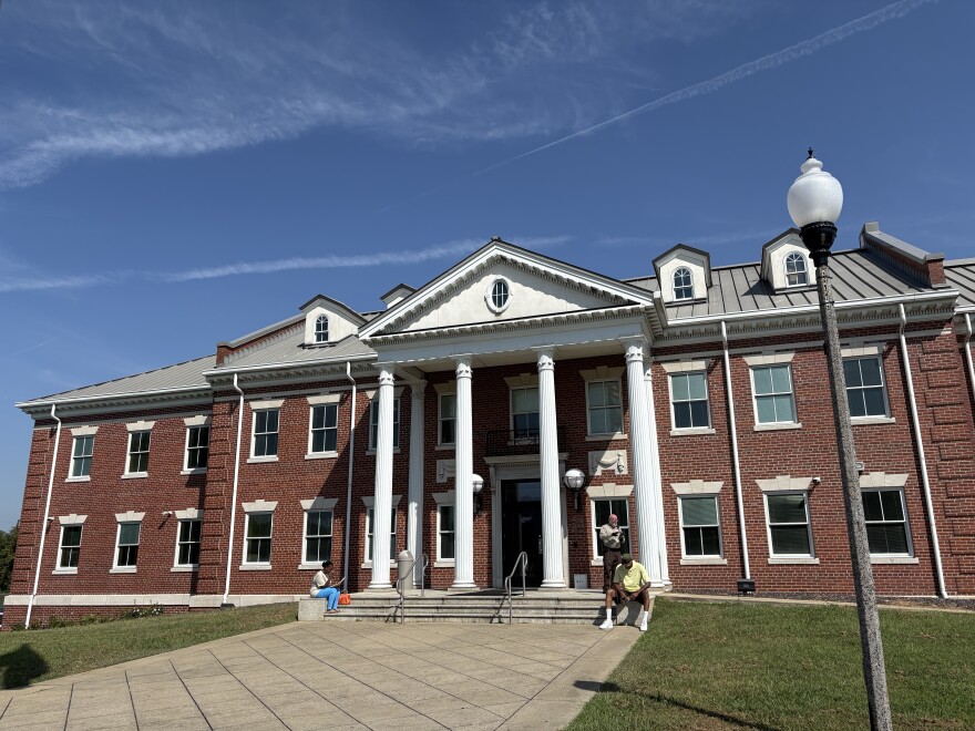 People sit outside of the Jefferson County Family Court building in Birmingham, Alabama