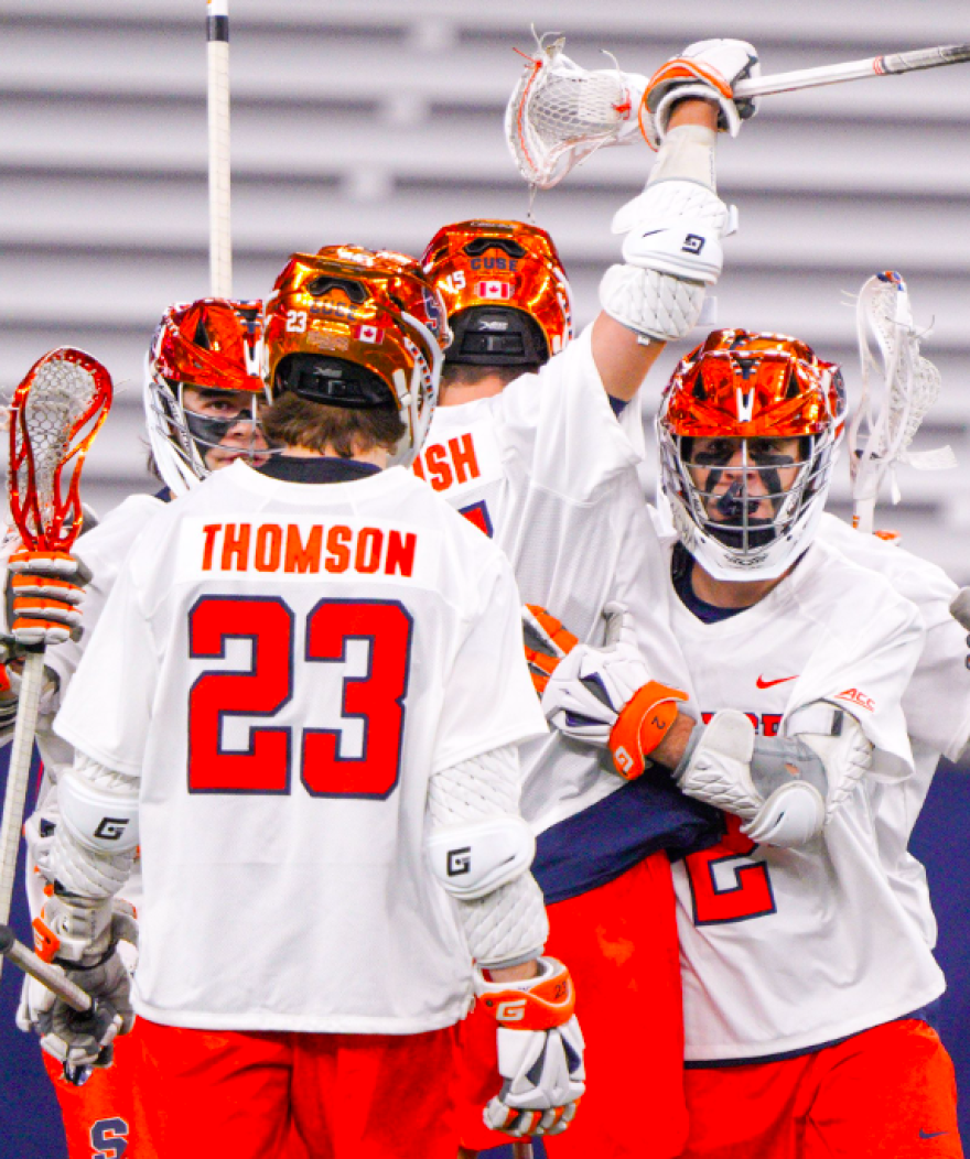 Syracuse attacker Finn Thomson (23, White) celebrates with his teammates in SU's win over Vermont