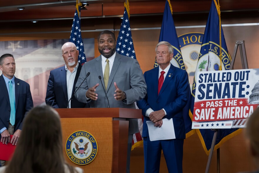 Rep. Byron Donalds, R-Fla., center, flanked by Rep. Chip Roy, R-Texas, left, and Rep. Ralph Norman, R-S.C., right, speaks to reporters as the conservative House Freedom Caucus slams the Senate for not acting on the Save America Act at the Capitol in Washington, Thursday, June 25, 2026.