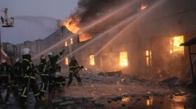 Ukrainian firefighters extinguish a blaze at a warehouse after a bombing in Kyiv, Ukraine, Thursday, March 17, 2022. Russian forces destroyed a theater in Mariupol where hundreds of people were sheltering Wednesday and rained fire on other cities, Ukrainian authorities said, even as the two sides projected optimism over efforts to negotiate an end to the fighting. (AP Photo/Vadim Ghirda)