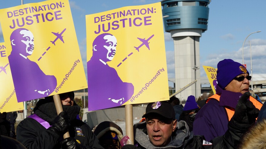 Airport workers rallied Monday for higher wages near LaGuardia Airport in New York City.