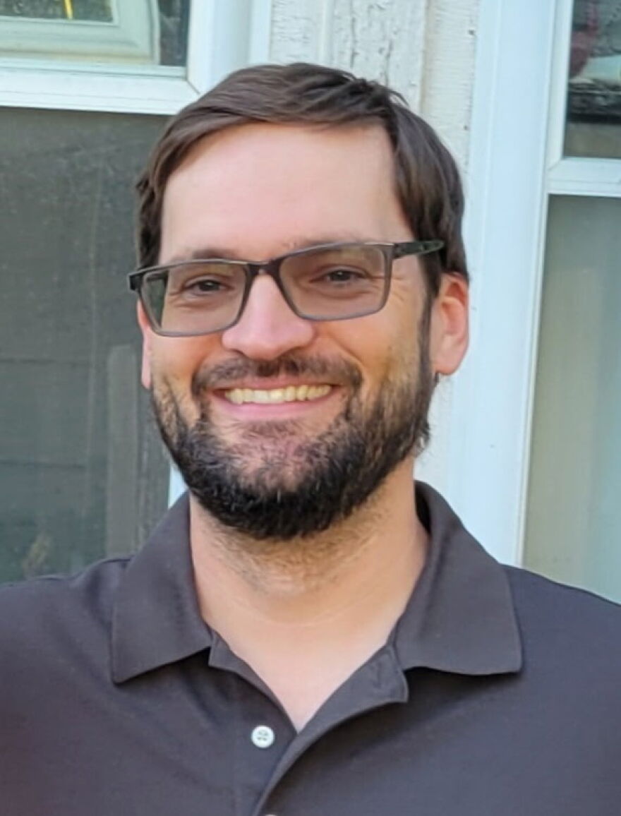 a man with a beard in a polo shirt