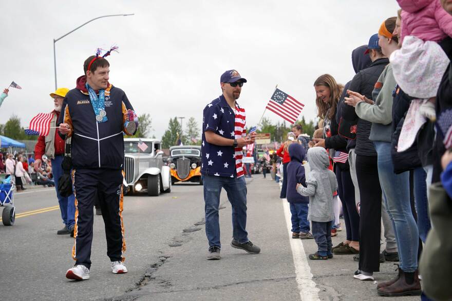 Jason Criss holds aloft his silver medal from the 2026 Special Olympics USA Games during the Independence Day parade in Kenai, Alaska, on July 4, 2026.