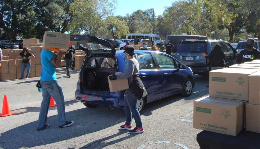 Volunteers load vehicles with food at The Change Church in Gotha on Monday morning. Photo: Joe Byrnes