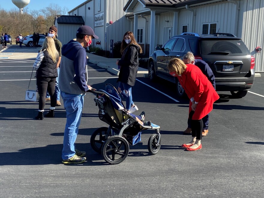The DeWines greet their son-in-law and grandson as they wait to vote.