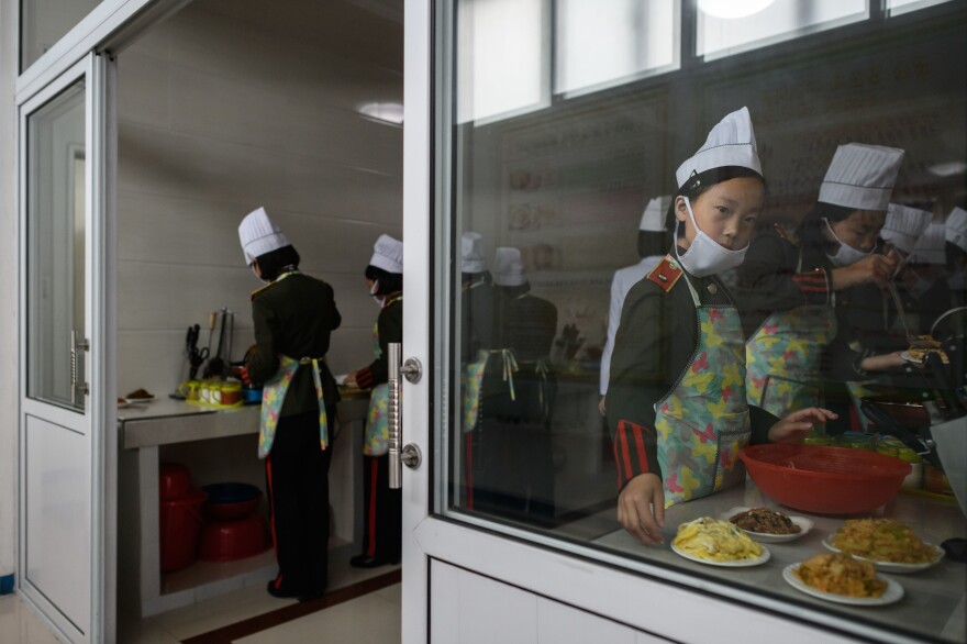 Female students participate in cooking lessons last month at the Kang Pan Sok military academy in Pyongyang. North Korea's business environment has been deeply destabilized by international sanctions, as evidenced by the report released Friday by the Bank of Korea.