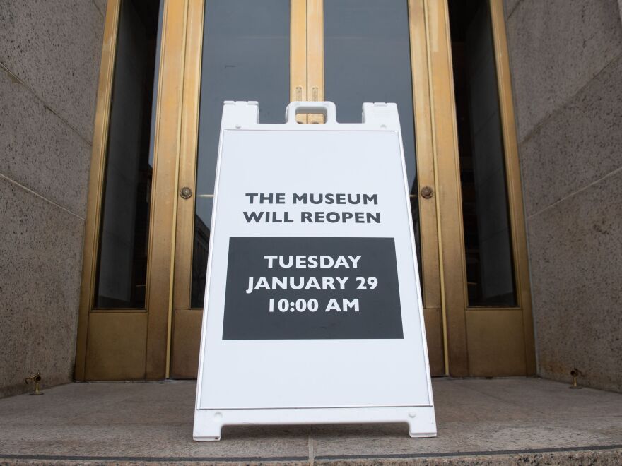 A sign at the entrance of the Smithsonian National Museum of Natural History in Washington, D.C., says the museum will reopen Tuesday. The shutdown reduced federal spending by $18 billion, although most of that will be recouped now that the government has reopened, according to a new report.