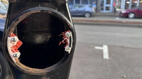 Old parking meter with scraps of plastic and metal.